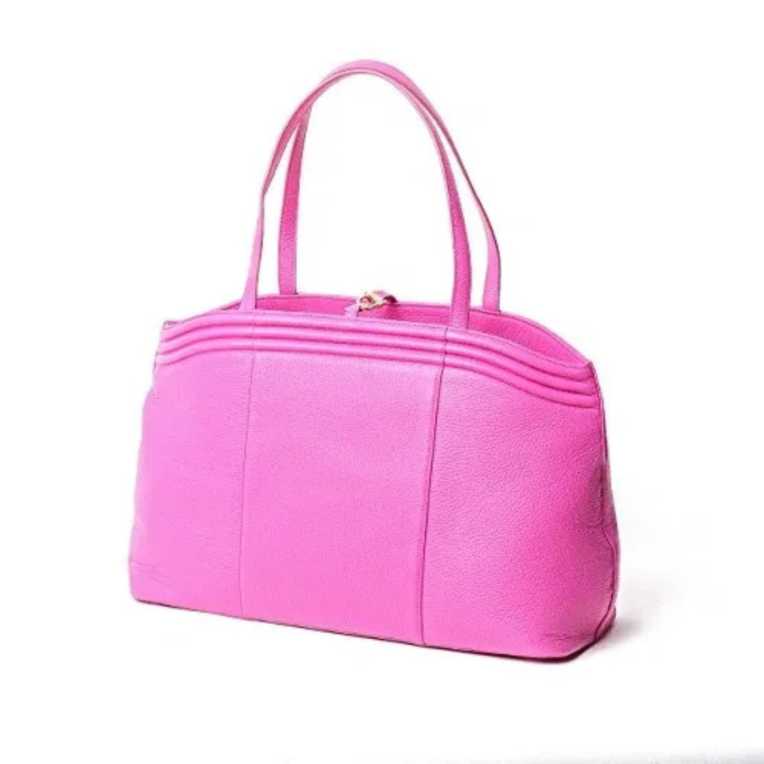 A pink purse is shown on the ground.