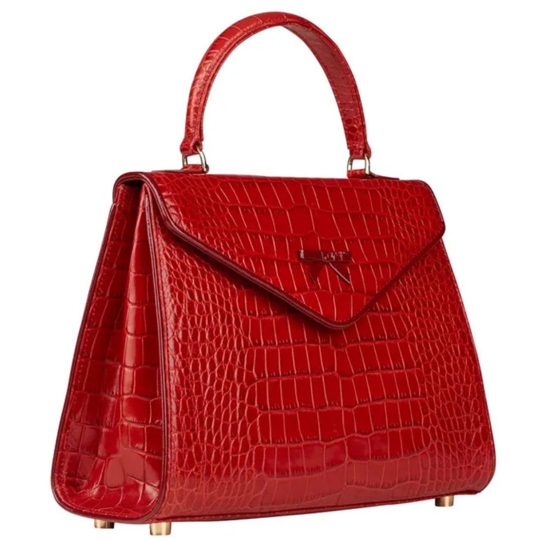 A red purse is shown with the handle down.