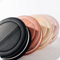 A group of different colored lids sitting on top of each other.